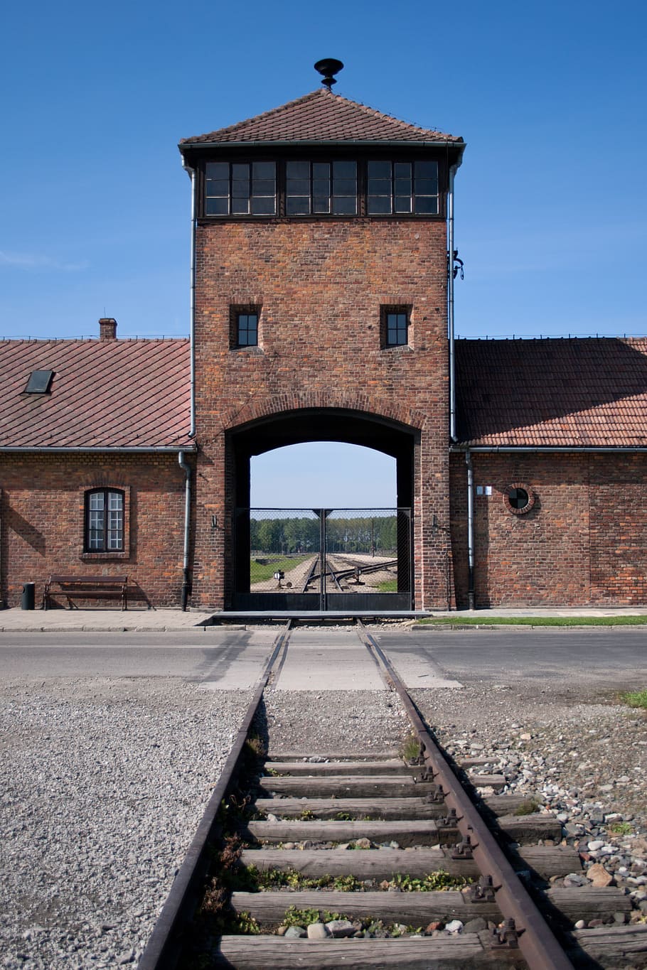 train station under blue calm sky, auschwitz, birkenau, holocaust