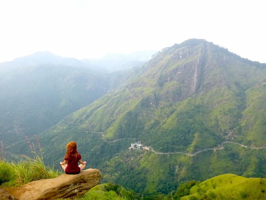 Omming it Up., woman wearing red shirt meditating above rock on mountain at daytime HD wallpaper