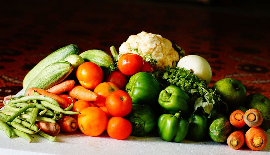several bunch of vegetables on brown surface, pile, white surface