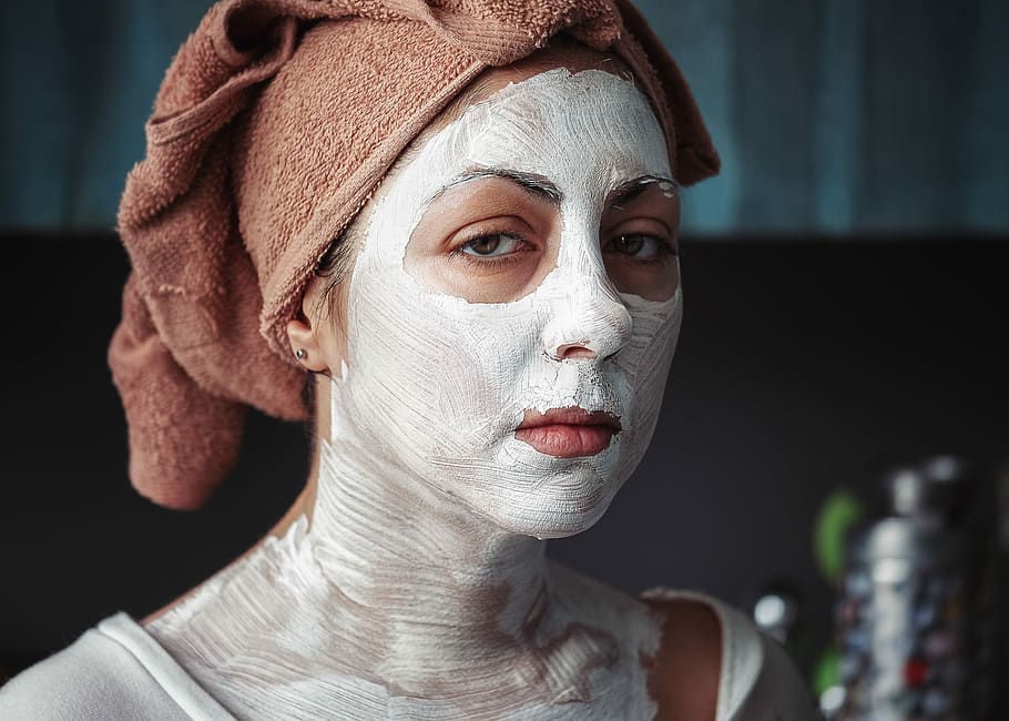 shallow focus photography of woman having a facial, woman cream mask in room HD wallpaper