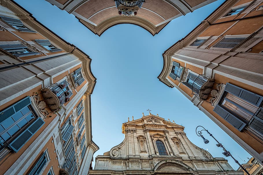 worm's eye view photography of brown buildings under clear blue sky during daytime HD wallpaper