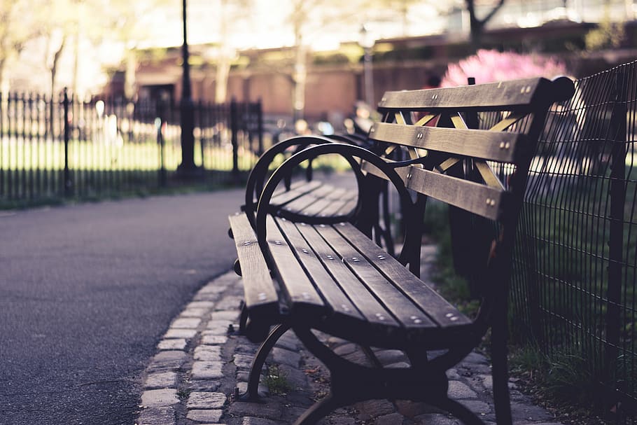 brown wooden bench beside black fence, selective focus photography of two benches beside park HD wallpaper