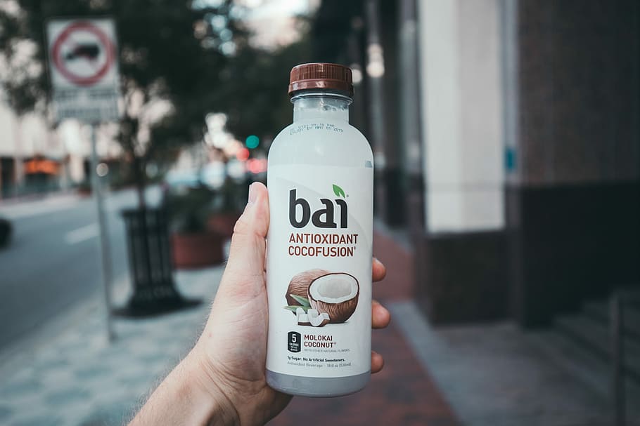 person holding Bai antioxidant cocofusion drink bottle, person holding Bai cocofusion drink bottle HD wallpaper