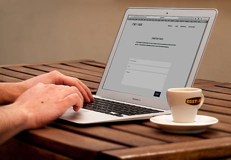 person using MacBook Air while having coffee, web, apple, graphics HD wallpaper