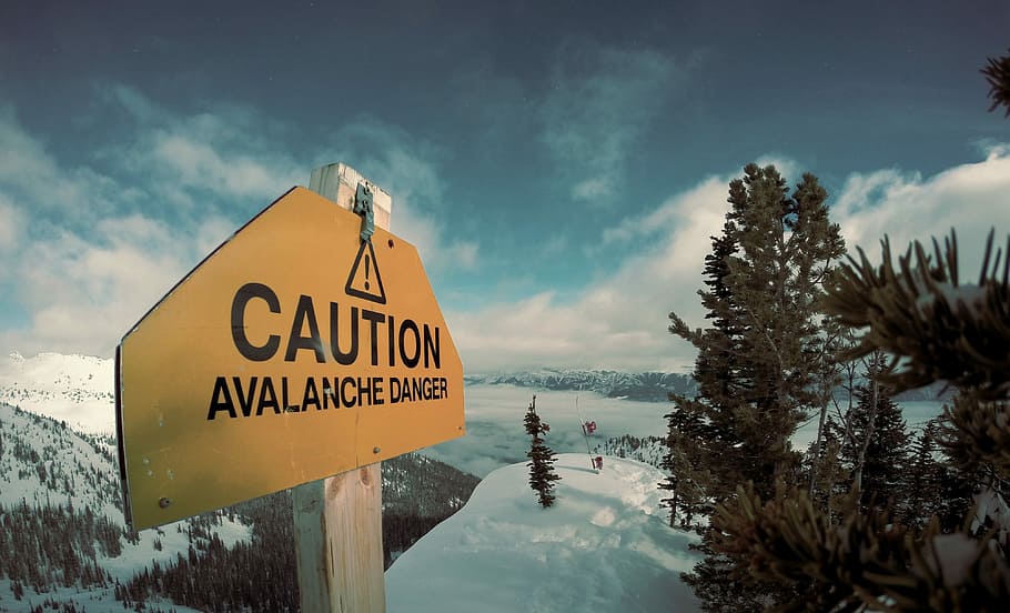 caution avalanche danger signage during winter, yellow and black Caution signage on snow-cover mountain HD wallpaper