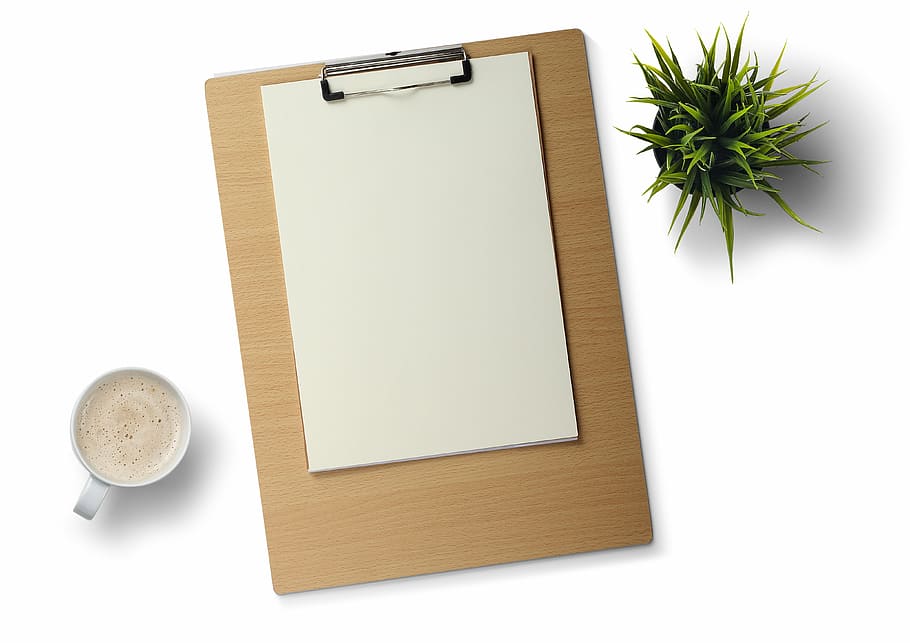 white printer paper on brown clip board, desk, white background