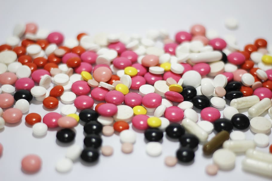 tilt shift photography of assorted-colors tablets, medications HD wallpaper