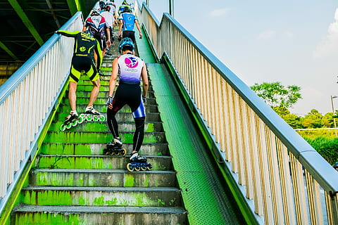 people wearing inline skates going upstairs, skaters going up stairs at daytime HD wallpaper
