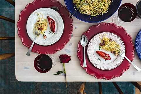 Fancy dinner with seafood pasta, crayfish and red wine by the table decorated with roses HD wallpaper