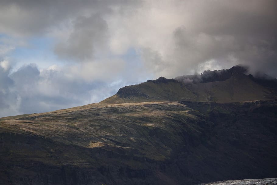 mountain under gray clouds, mountain range covered with clouds at daytime HD wallpaper