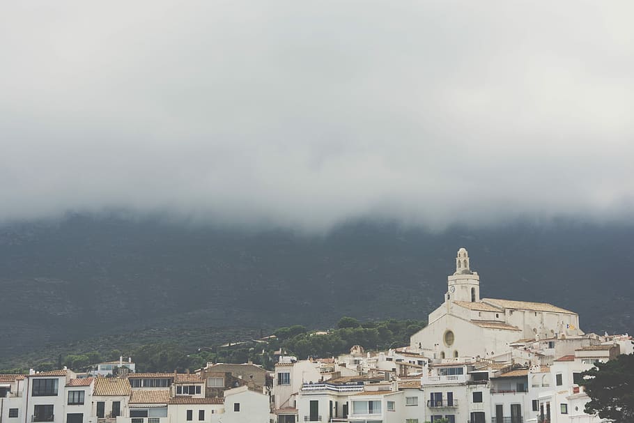 aerial photograph of city, white cathedral under cloudy sky, church