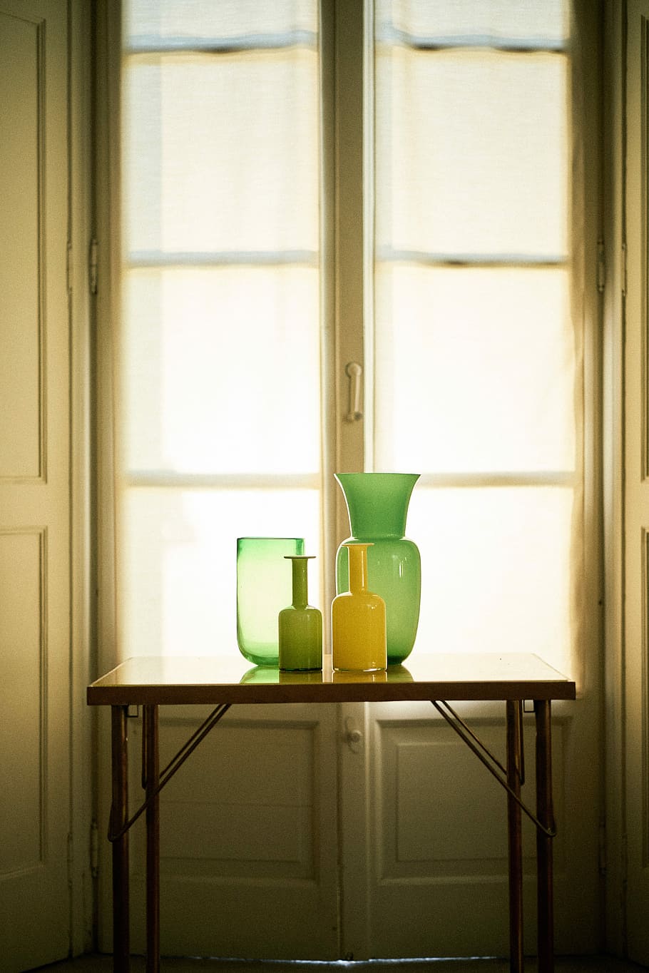 photo of vases on top of table in front of window, four assorted glass vases HD wallpaper