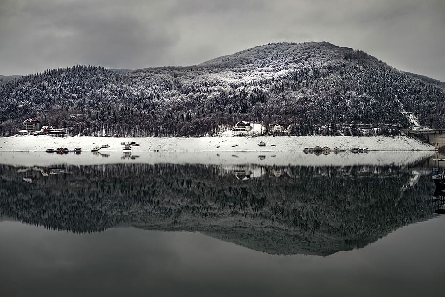 landscape photography of mountain with body of water at bottom, mountain beside body of water under dark clouds HD wallpaper