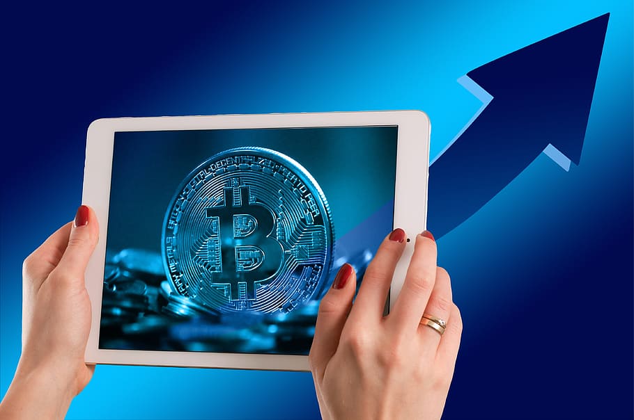 person holding iPad displaying Bitcoin wallpaper, money, electronic money