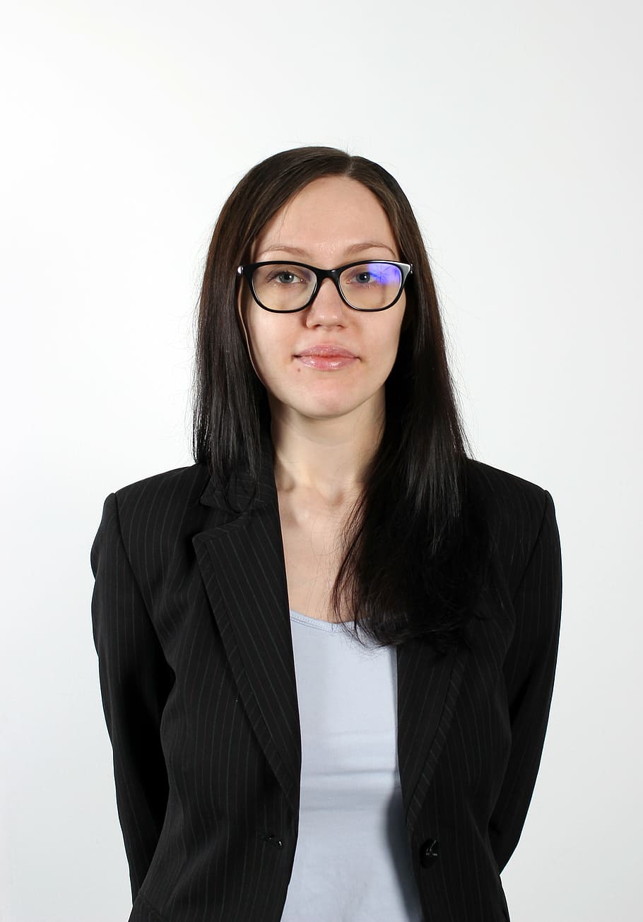 photo of woman wearing black blazer, glasses, business woman