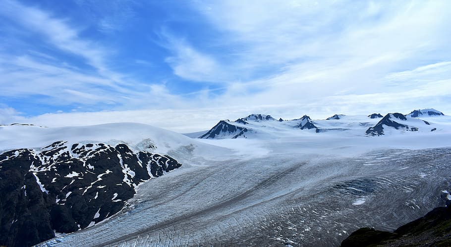 mountain covered with snow under white clouds, snow covered land under blue sky HD wallpaper