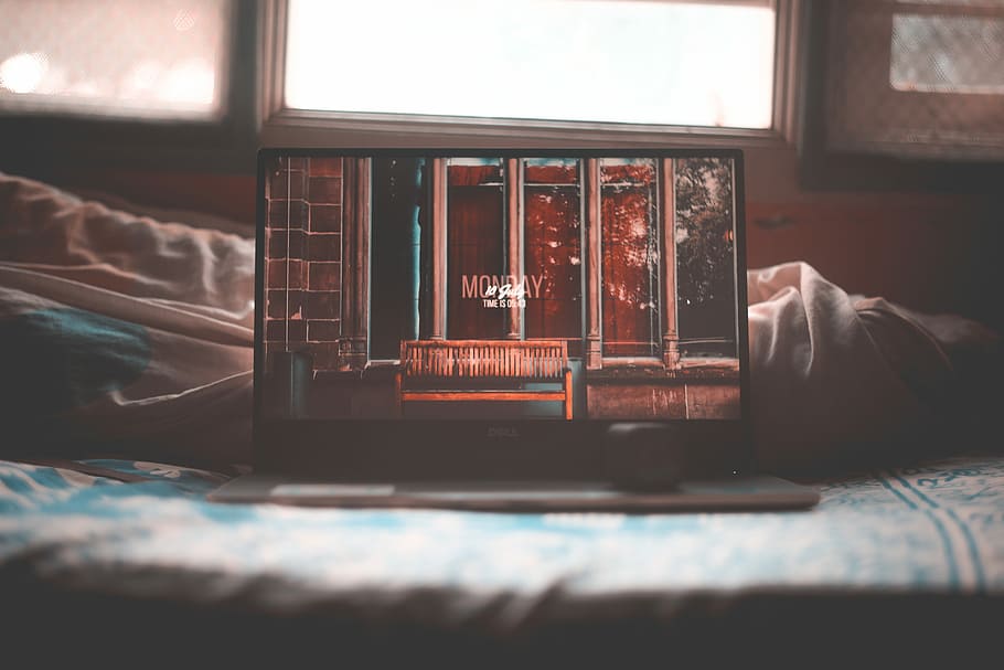 tilt shift lens photography of black laptop computer on gray textile, black Dell laptop turn on place on bed near window HD wallpaper