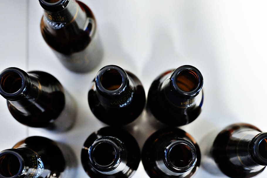 aerial photography of black bottles, eight bottles on white surface HD wallpaper