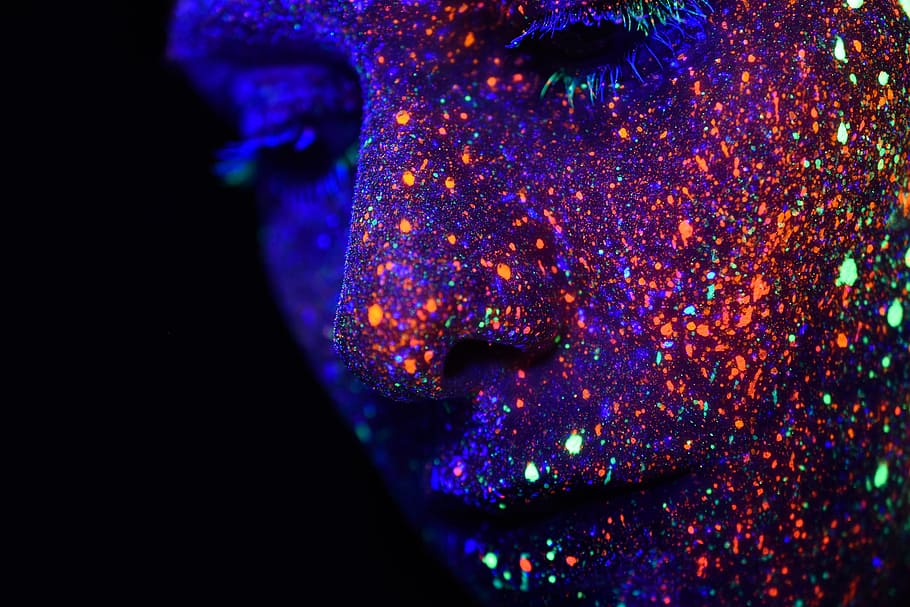 person with assorted-color paint on face, person's face with neon paints