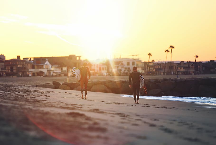 two men carrying surfboards during sunset, walking, beach, sea HD wallpaper