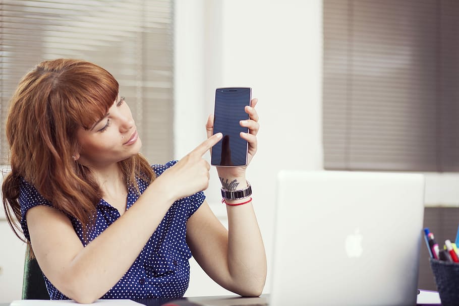 woman holding an Android smartphone, woman in blue dress holding black smartphone HD wallpaper