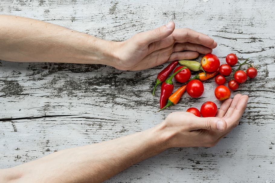 person hand's about to get cherry tomatoes and bell peppers, tomato and bell peppers on top of white wooden board HD wallpaper