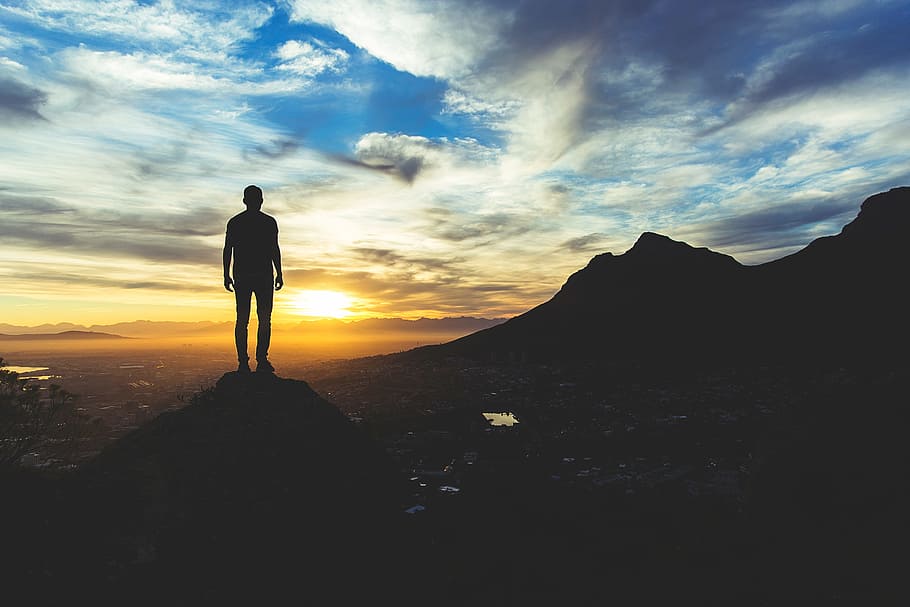 silhouette photo of a man standing of cliff, valley, hill, sunset HD wallpaper