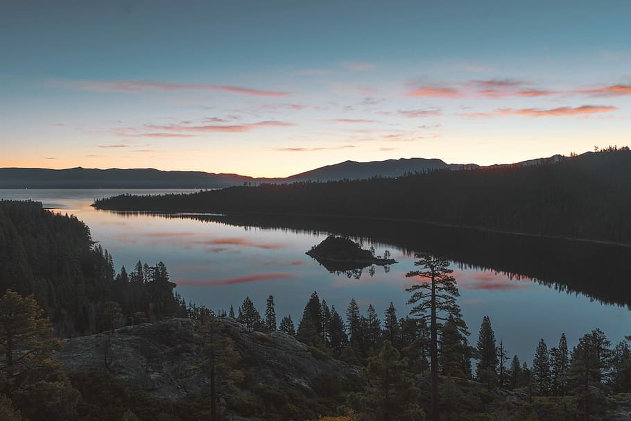 body of water across mountain, landscape photography of lake between trees HD wallpaper