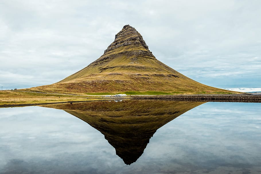 brown mountain near body of water during daytime, daylight HD wallpaper