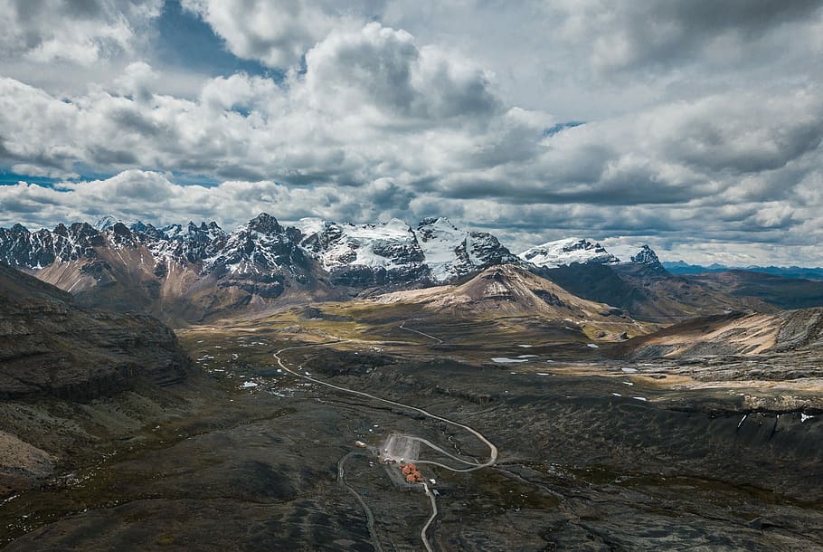 aerial photo of mountain under cloudy sky, bird's eye view photography of road towards mountains HD wallpaper