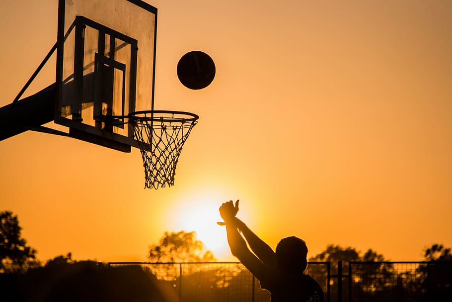 silhouette photo of a person playing a basketball, sport, game