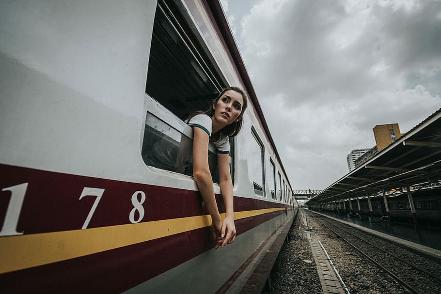 woman's head and hands outside train under cloudy sky during daytime, woman in train HD wallpaper