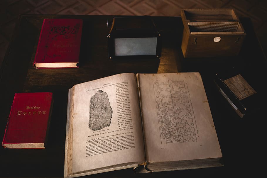 opened book on desk, opened book on black wooden table in room HD wallpaper