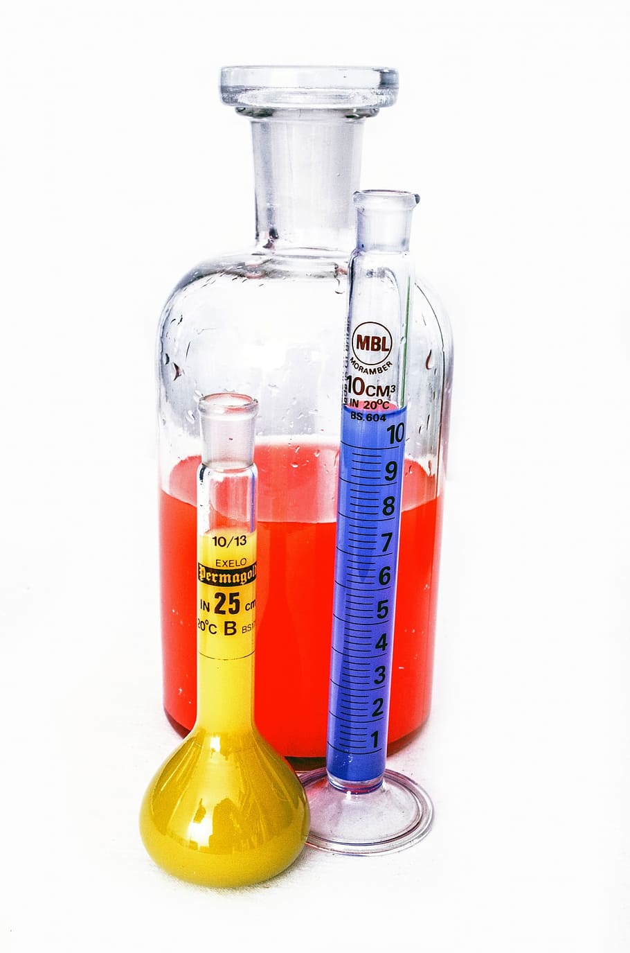 three assorted laboratory instruments filled with liquids, research