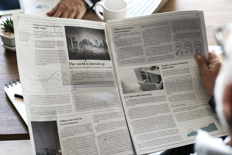 person holding newspaper in front of cup, one person, reading HD wallpaper