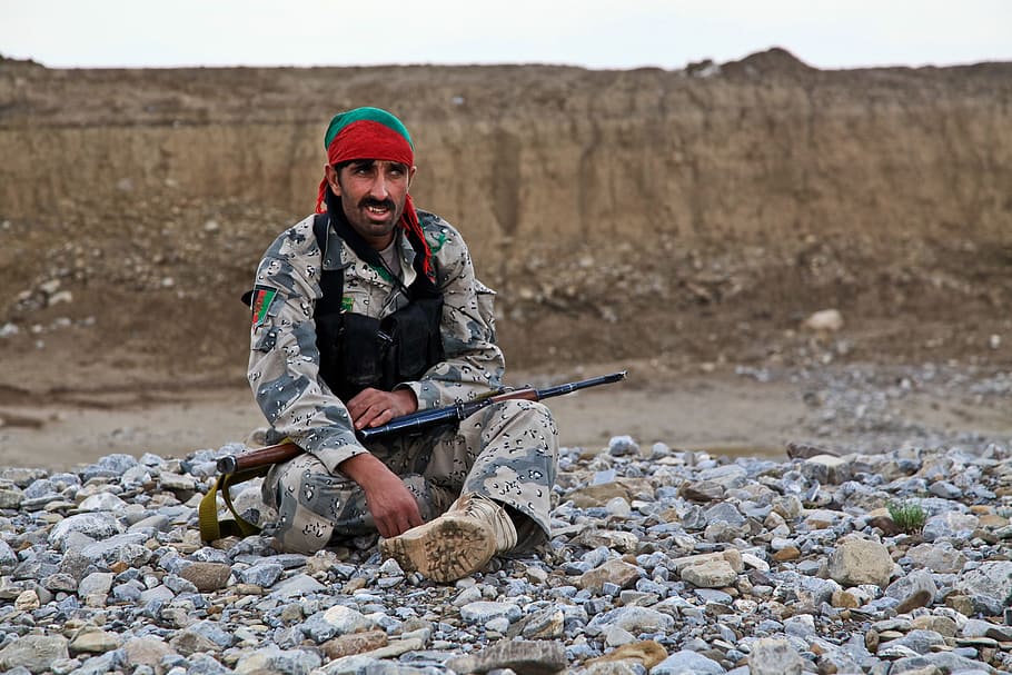 military man sitting on rocks, fighter, weapon, afghani, rebel HD wallpaper