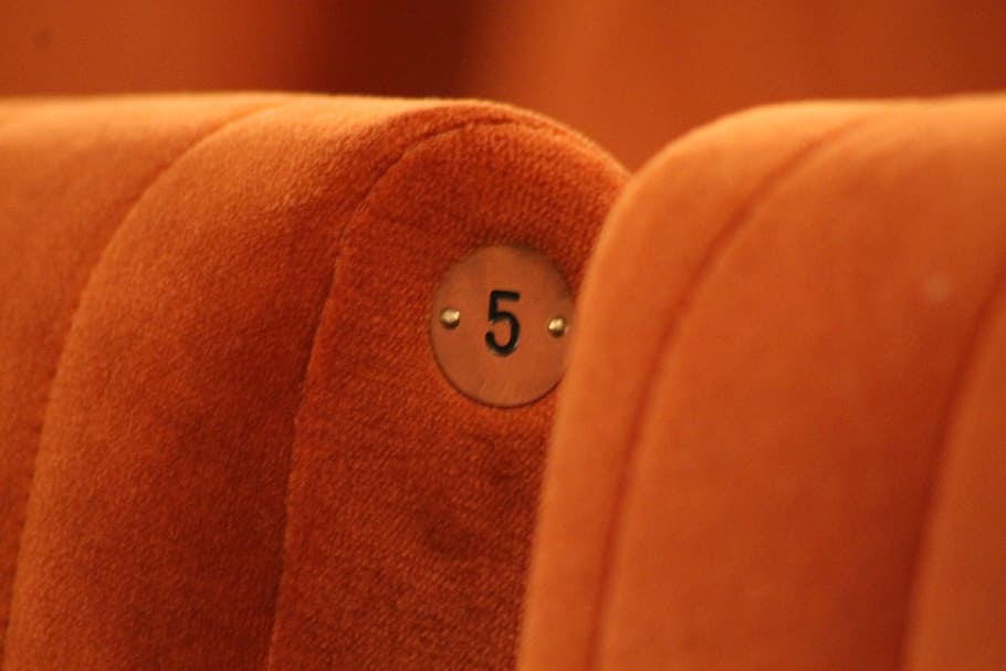 orange fabric chair in close-up photo, Five, Number, Theater