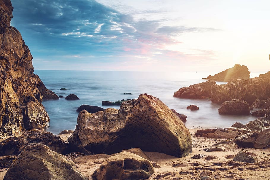 brown rocky formations, photography, near, body, water, daytime HD wallpaper