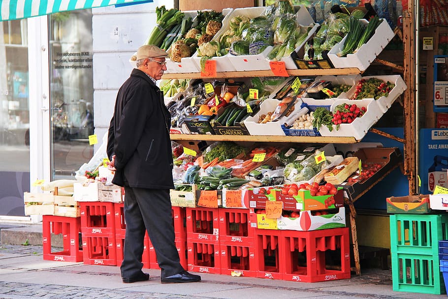 man looking at vegetables display, stall, shop, market, fresh