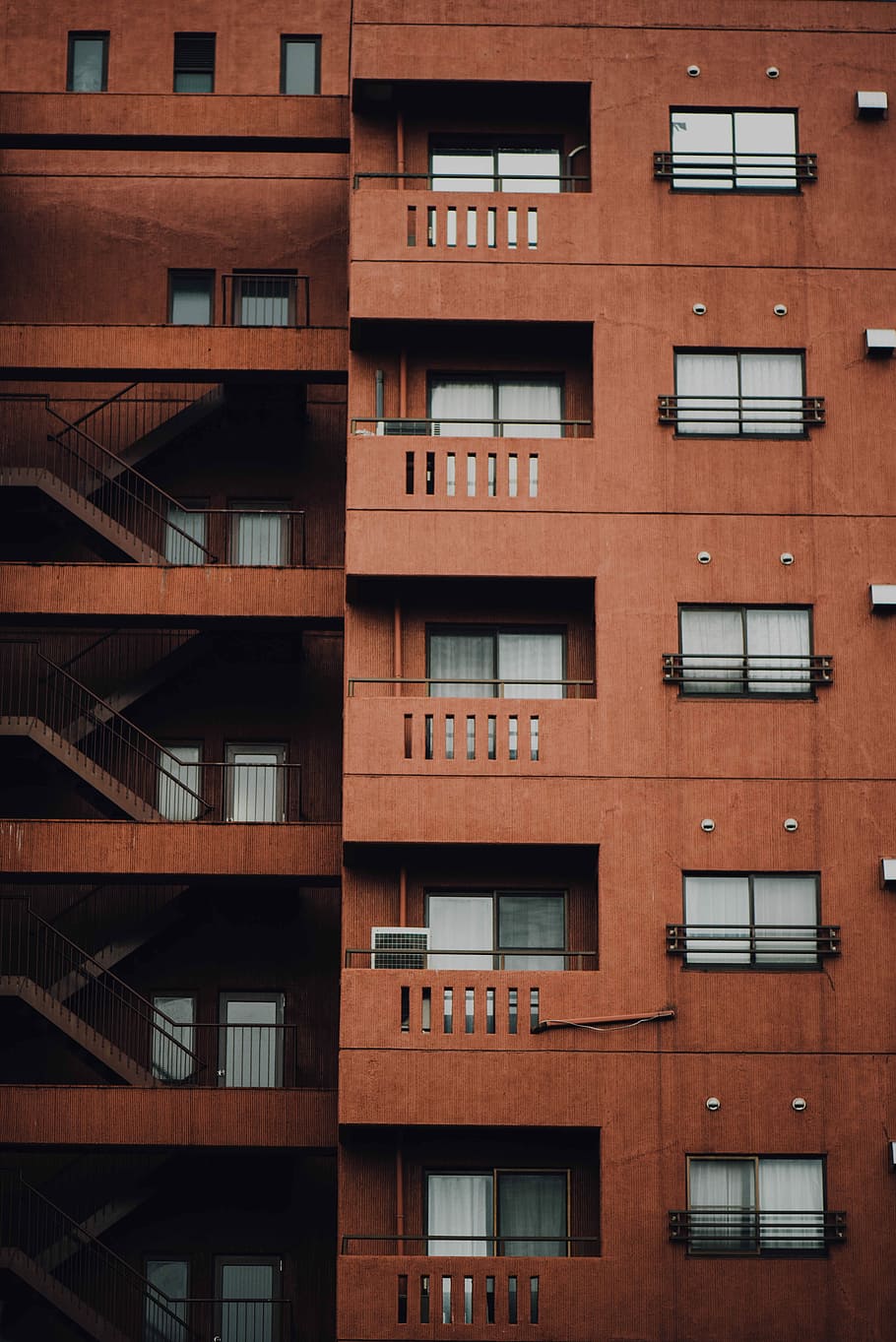 brown concrete building with stairs on the side, brown building photo at daytime HD wallpaper
