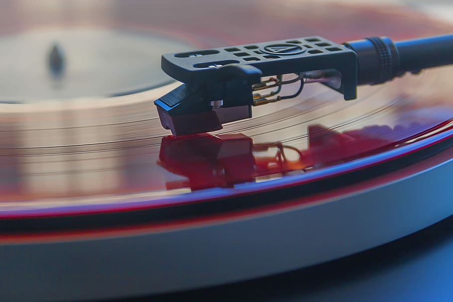 closeup photography of vinyl record in vinyl player, gray and red turntable
