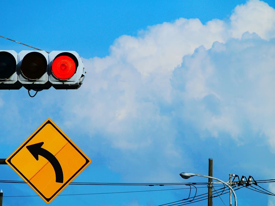 red light, traffic signs, curve, yellow, blue sky, towering cumulus clouds observed
