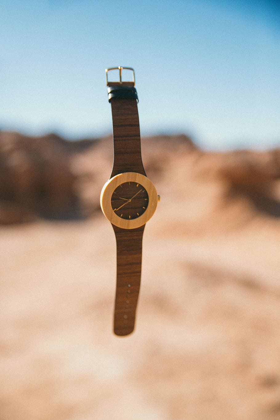 time lapse photography of falling analog watch, round brown analog watch with strap HD wallpaper