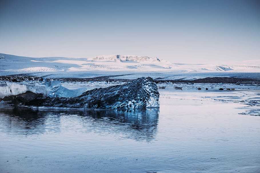 body of water, photo of snow-covered island under cloudy blue sky HD wallpaper