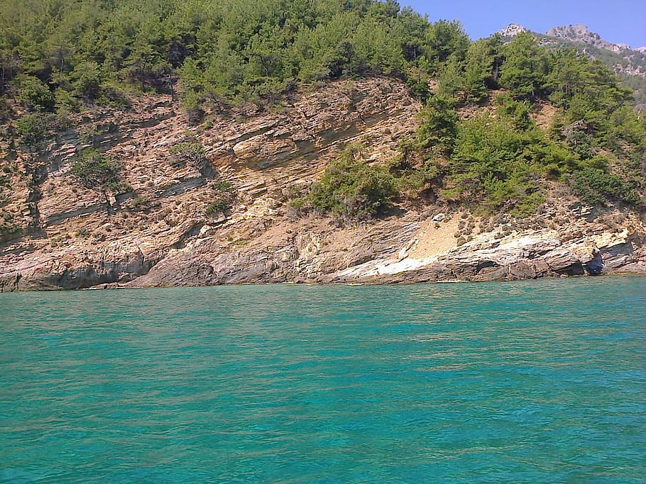 body of water near rock mountain with trees, thassos, greece HD wallpaper