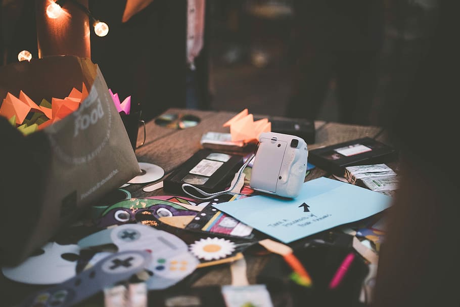 white camera on table, white instant camera on desk, game, clutter HD wallpaper