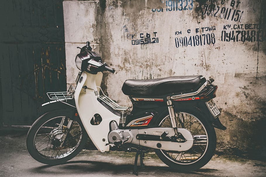 white and black underbone motorcycle parked near the wall, underbone motorcycle parked beside building at daytime HD wallpaper