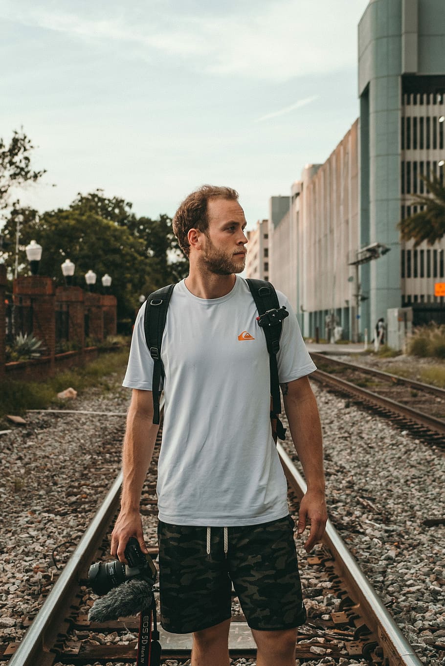 man standing on train rail at daytime, man on railroad, camera HD wallpaper