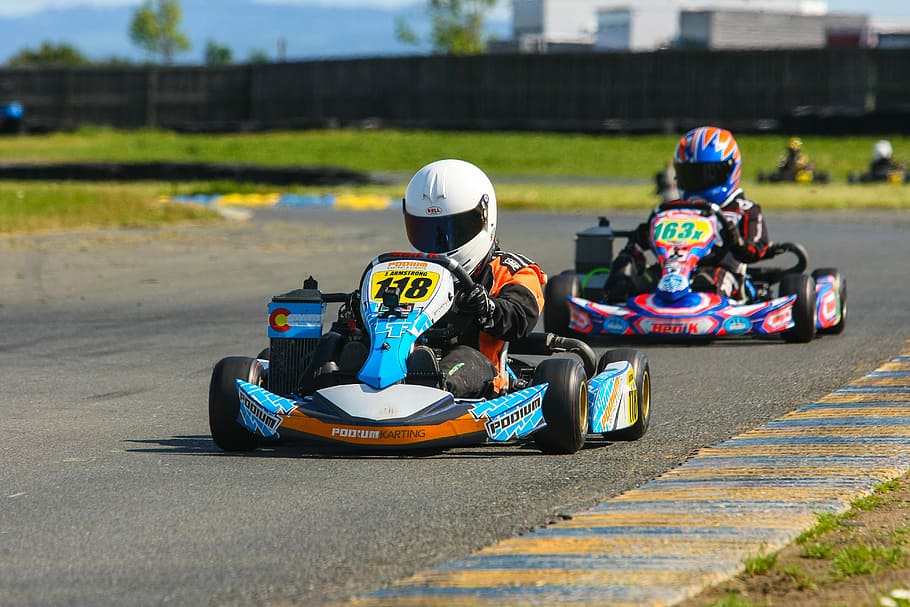 Jack Armstrong - Going for the Championship, two person driving go kart on track at daytime