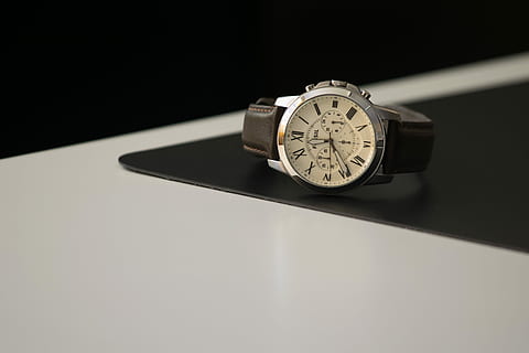round silver-colored chronograph watch with black leather strap, white analog watch on white and black table HD wallpaper
